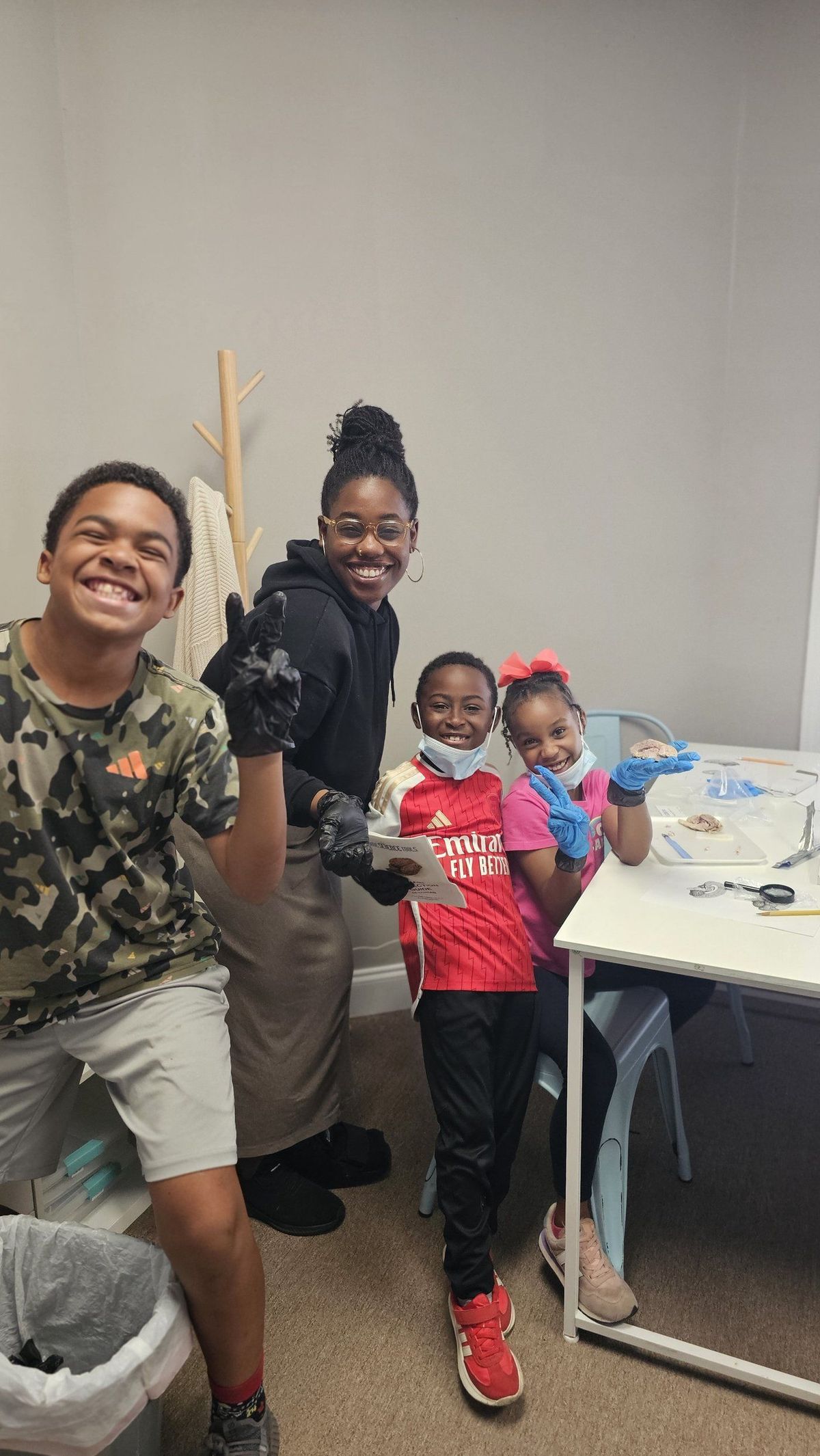 Guide and scholars celebrating during brain dissection lab